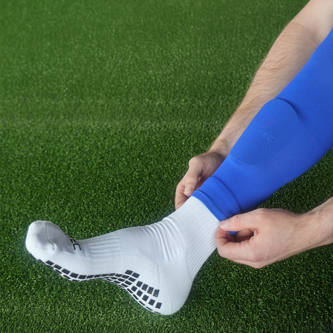 Soccer player with Griptec mini shin pads and grip socks and sock sleeves