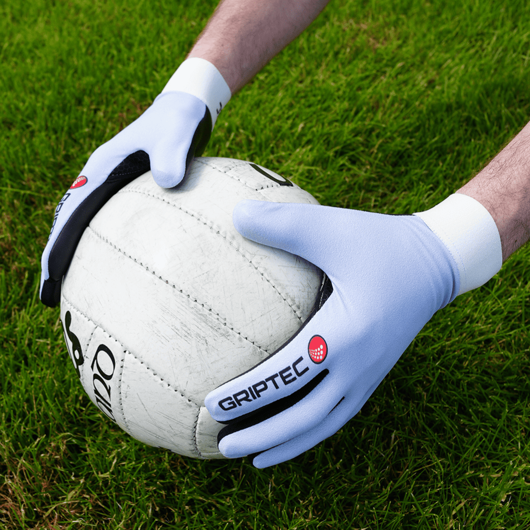 Player catching a football wearing GRIPTEC Gaelic football gloves
