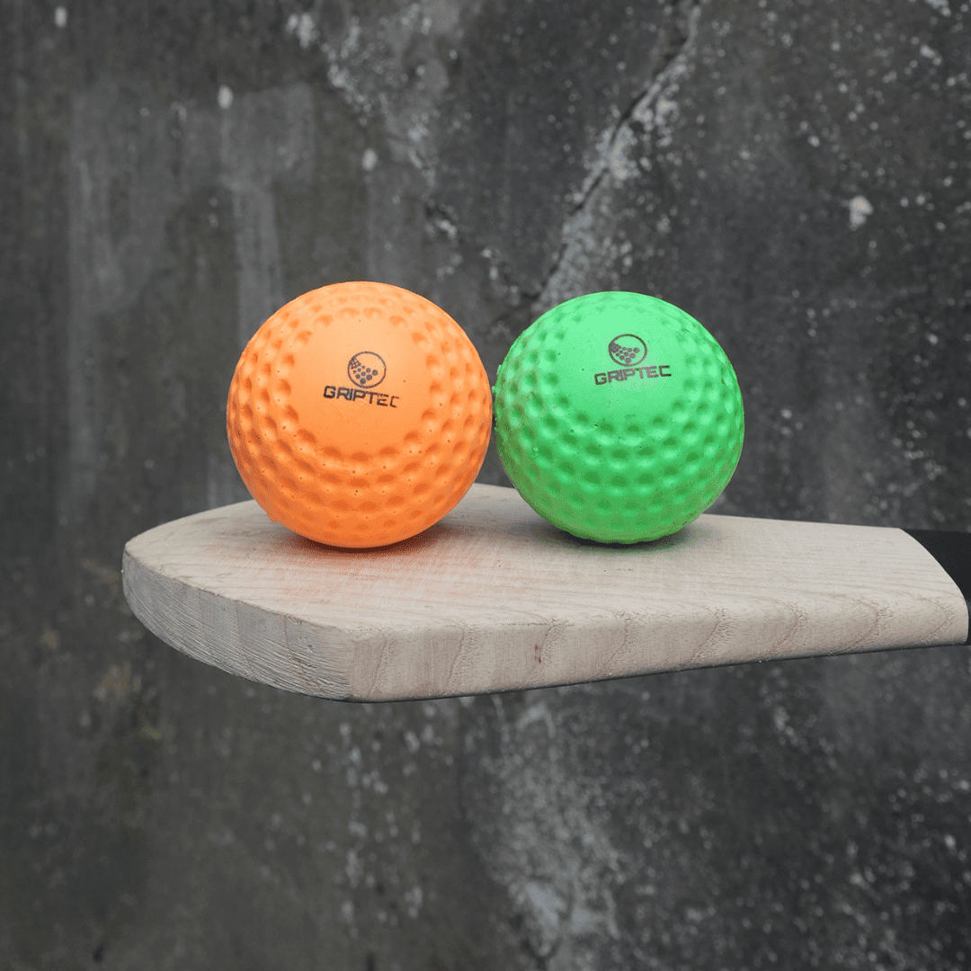 GRIPTEC hurling speed balls in size 4 and size 5 beside a hurley
