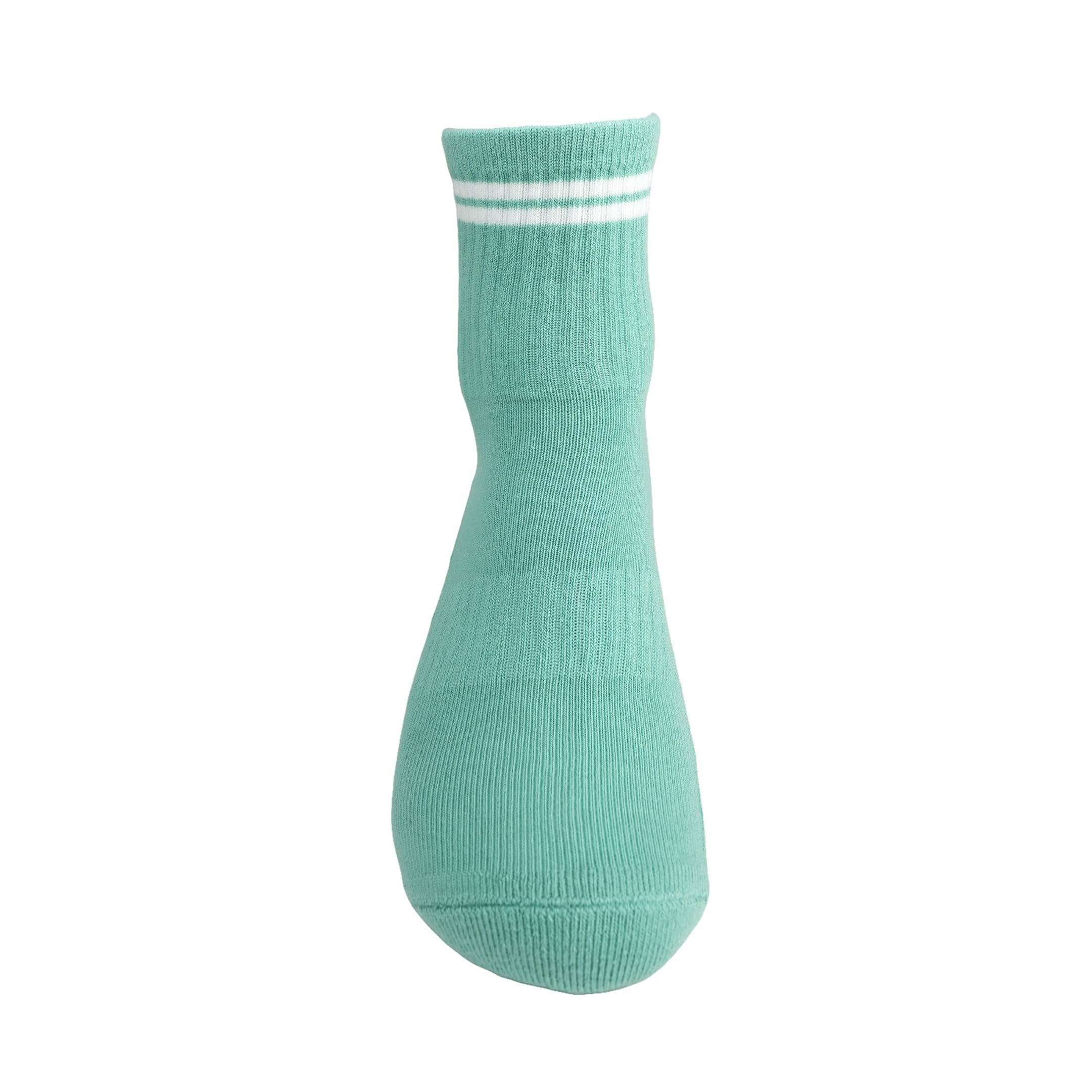 Green and white GRIPTEC pilates grip socks, front view