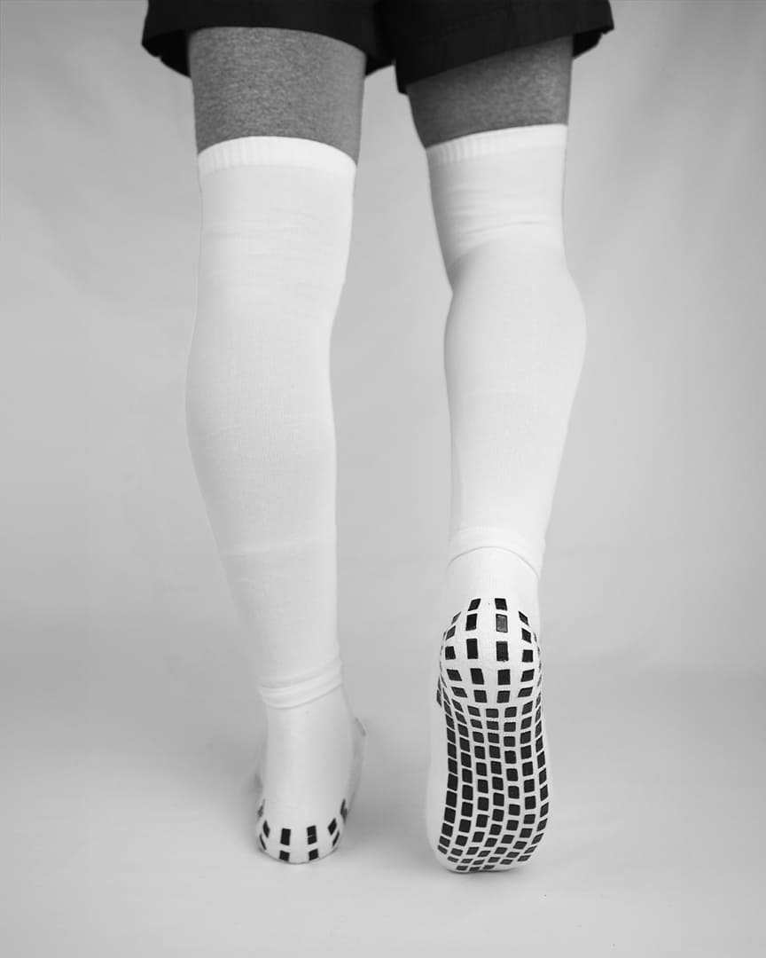Player wearing white GRIPTEC sock sleeves over white grip socks