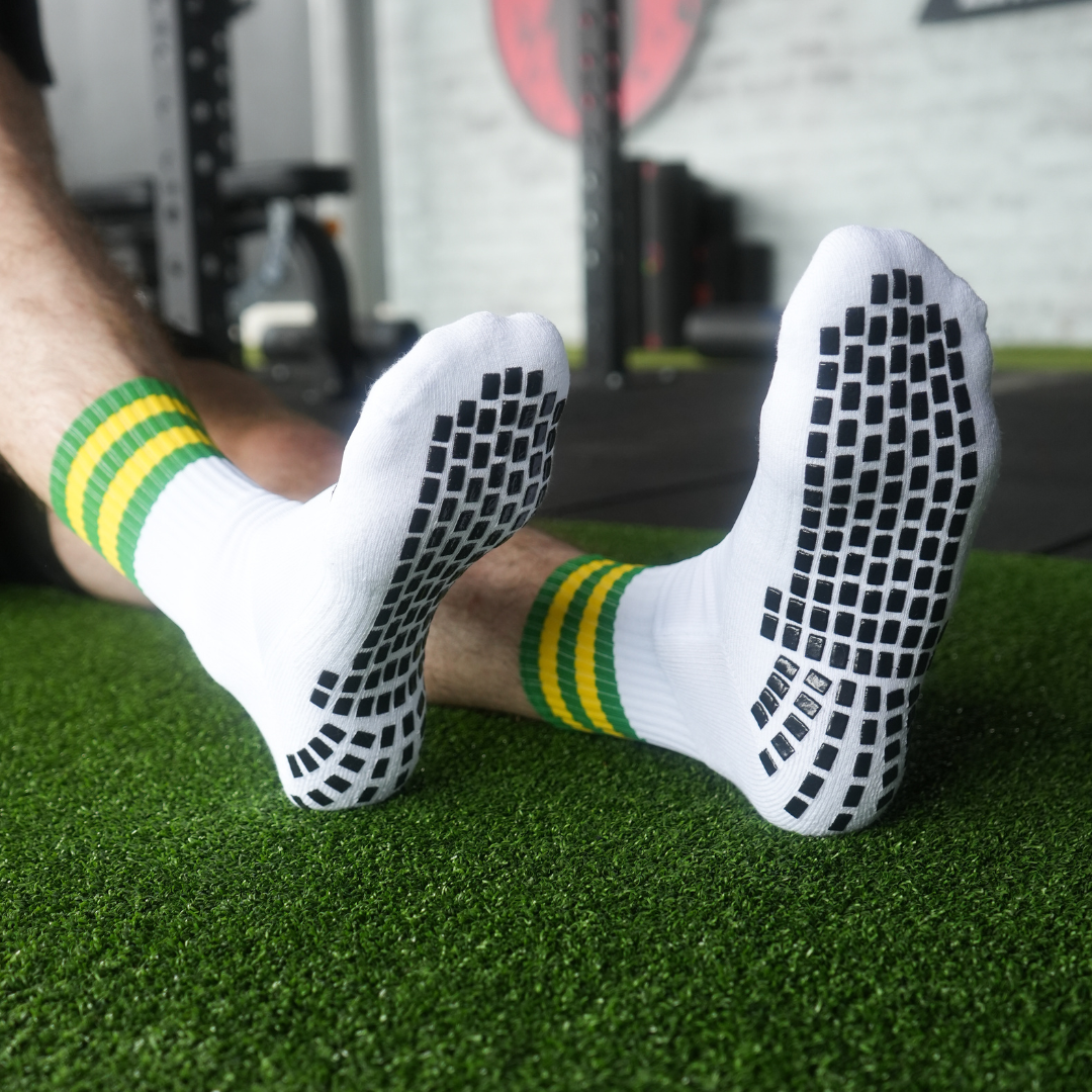 green and white grip socks with grass