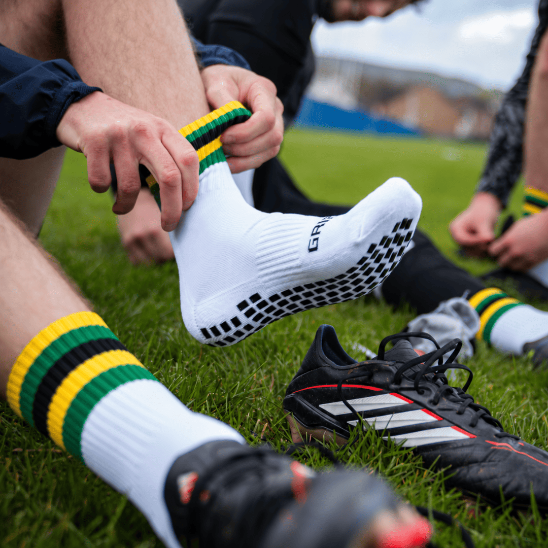 Putting on yellow, green and black GRIPTEC Grip Socks
