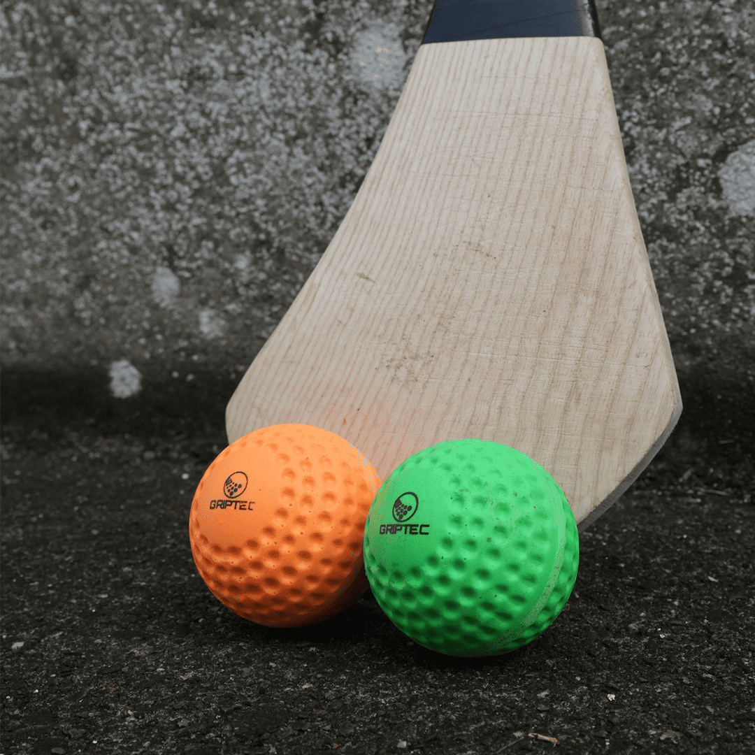 GRIPTEC hurling speed ball training against a wall with a hurley