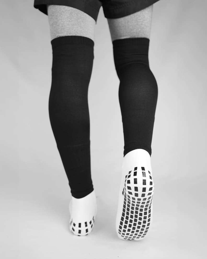 Player wearing black GRIPTEC sock sleeves over white grip socks