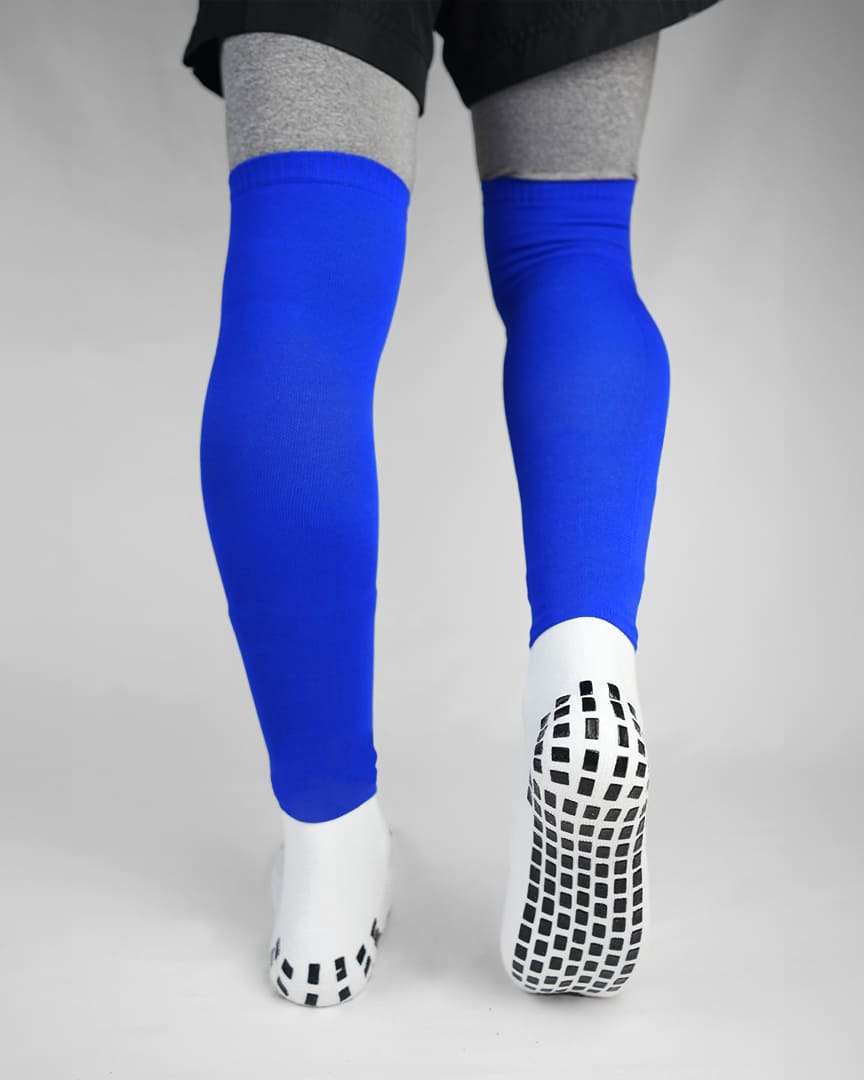 Player wearing blue GRIPTEC sock sleeves over white grip socks