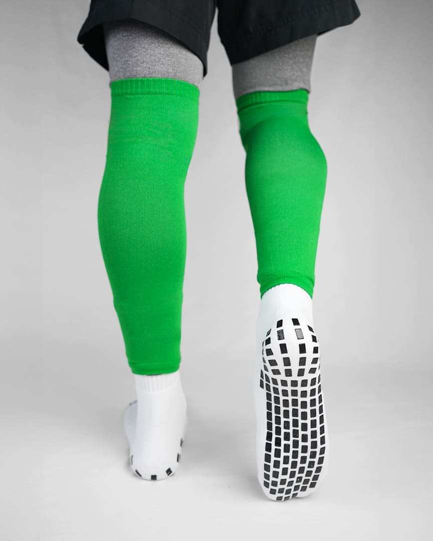 Player wearing green GRIPTEC sock sleeves over white grip socks